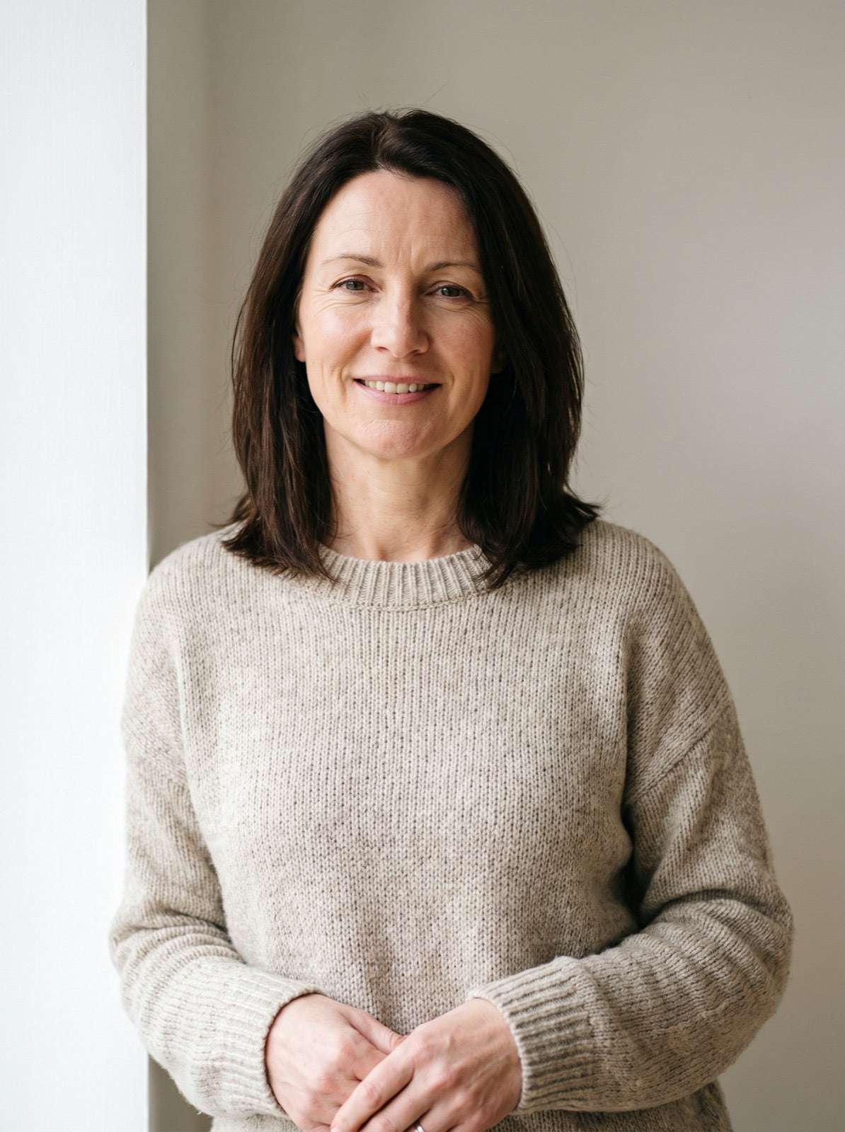 Portrait of a smiling woman with a long brown bob Image