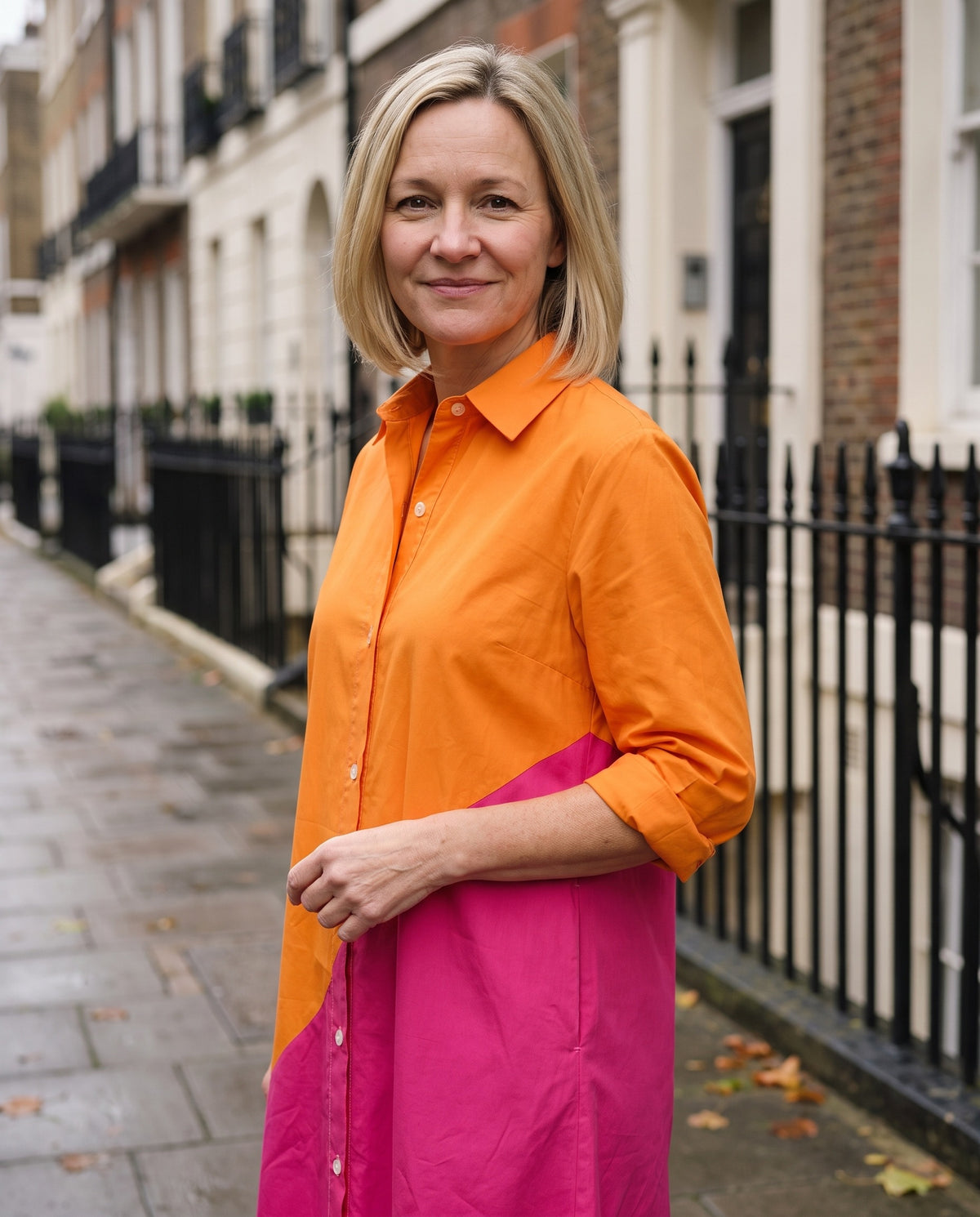 Woman wearing the colorblock button-front shirt midi dress with pockets, close-up of the neckline and fabric
