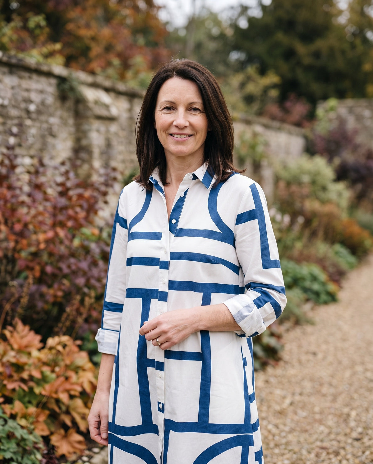 Woman wearing the sophisticated midi dress, close-up of the neckline and fabric