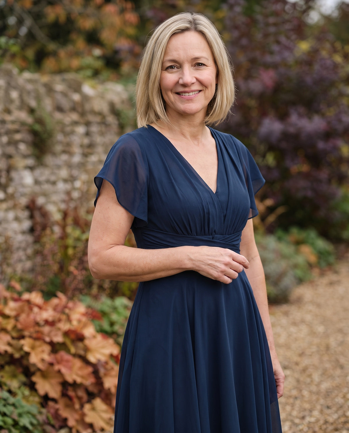 Woman wearing the v-neck a-line dress, close-up of the neckline and fabric Image