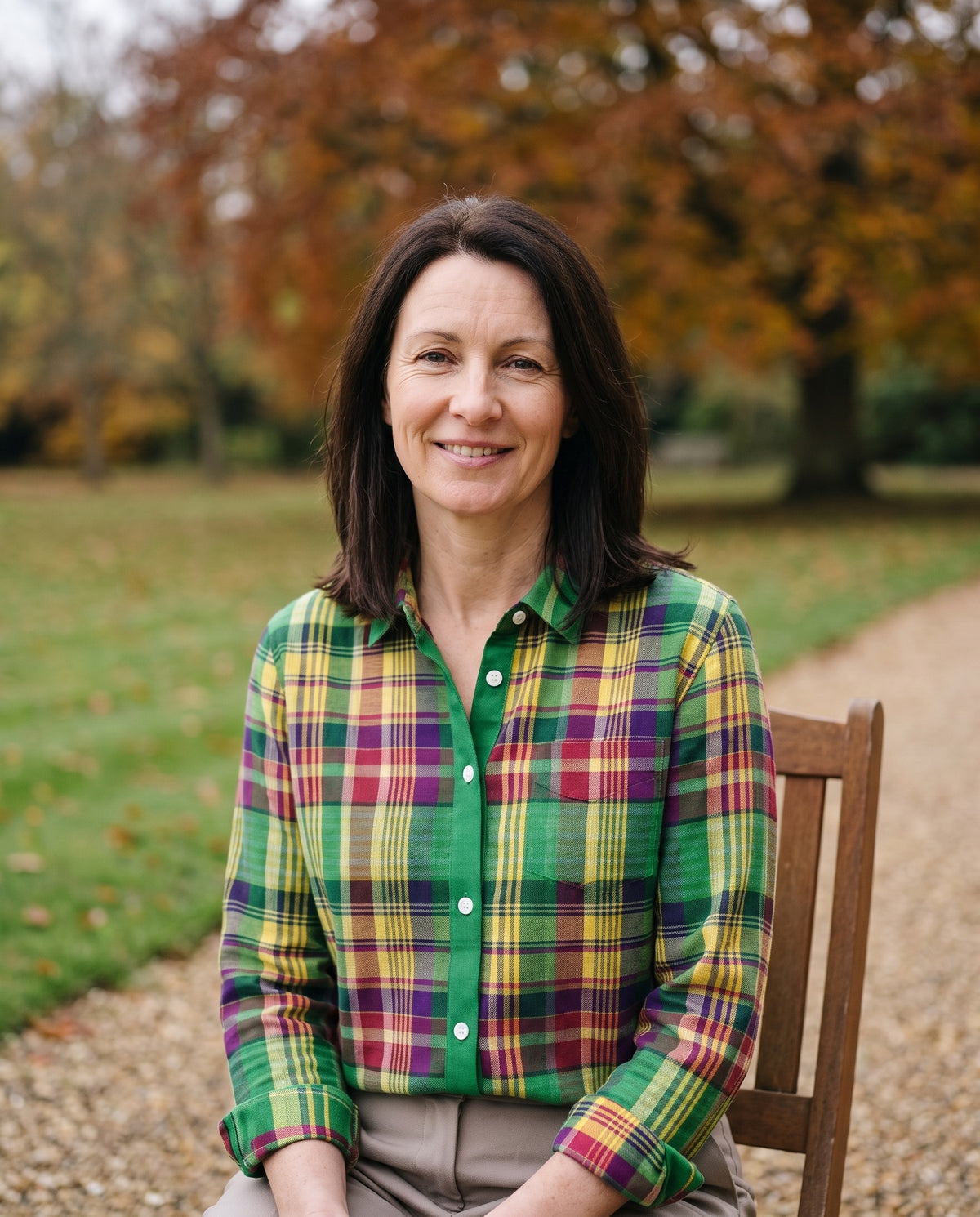 Woman wearing the checked blouse in vibrant green tones, close-up of the neckline and fabric