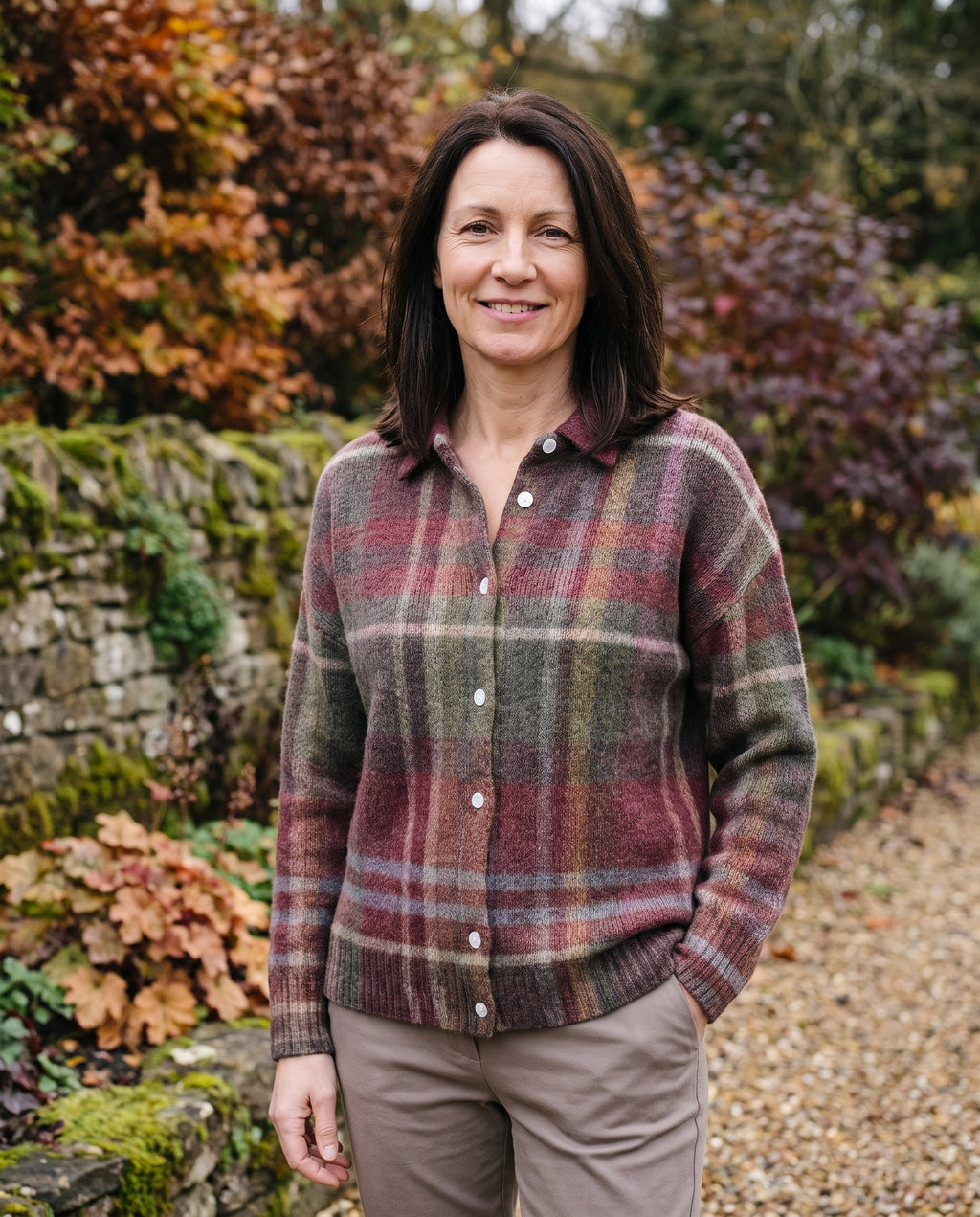Woman wearing the checked knit blouse in an autumn English garden