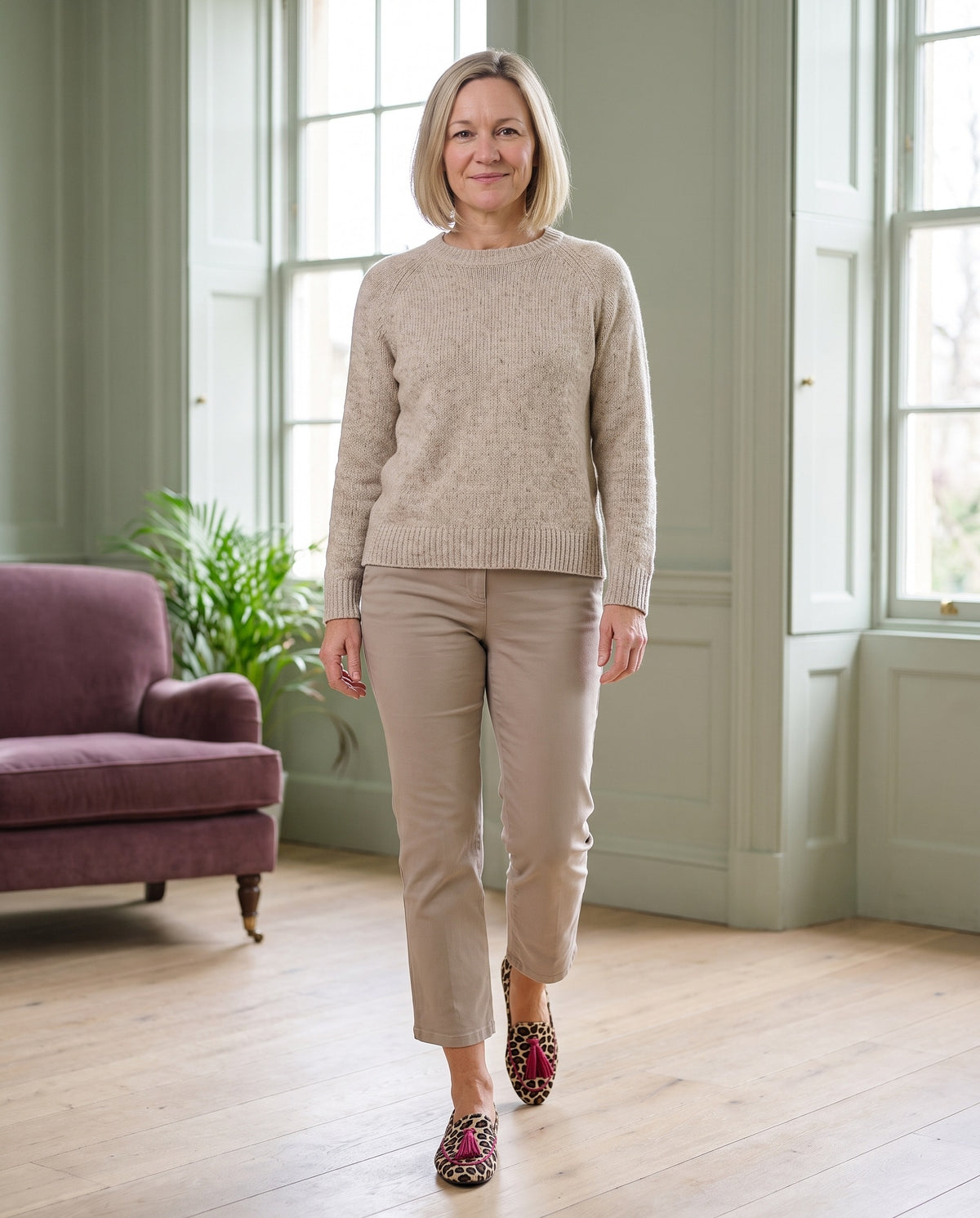Woman wearing the slippers with fringe details in a bright Georgian interior Image