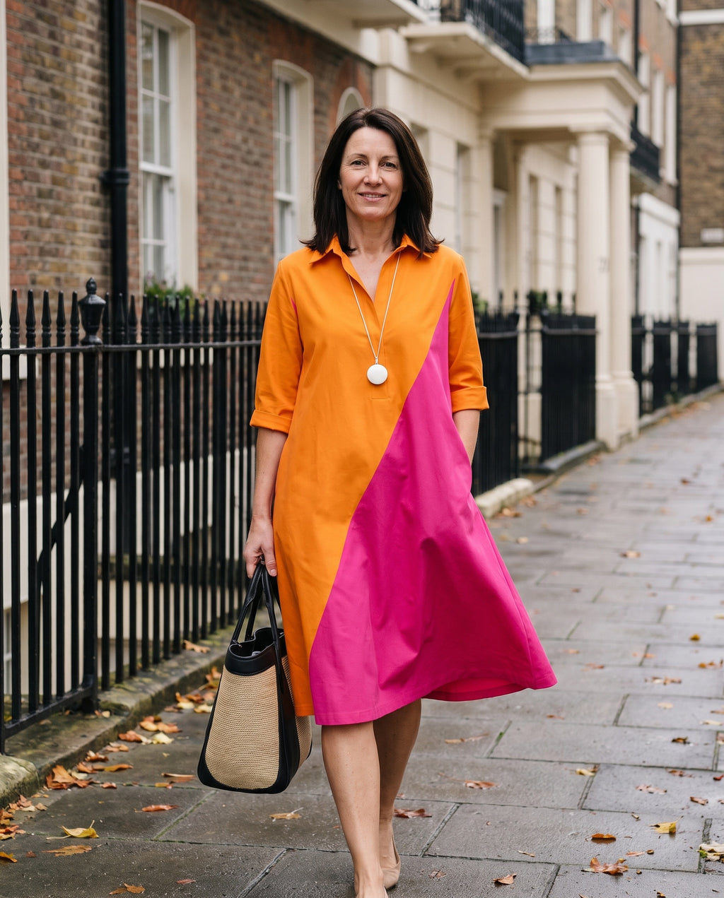 Woman wearing the midi dress diagonal colourblock cotton collared v-neck on an English residential street