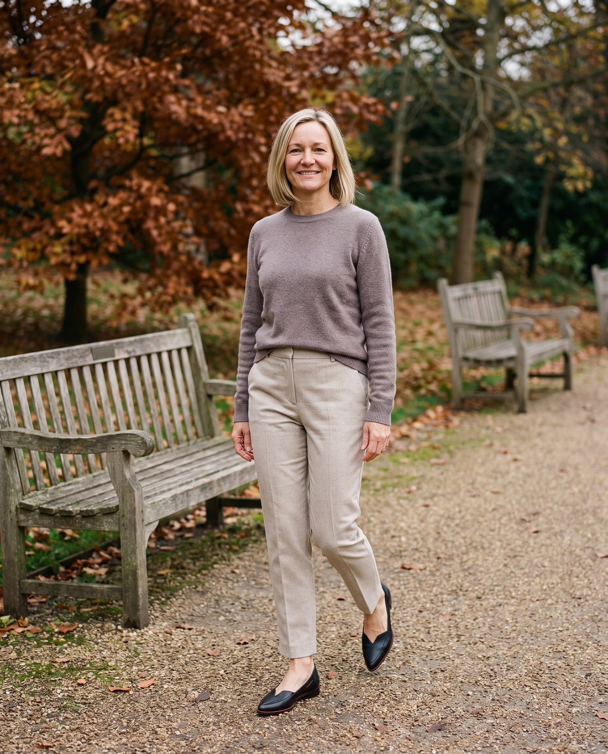 Woman wearing the elegant sandals in an English park in autumn
