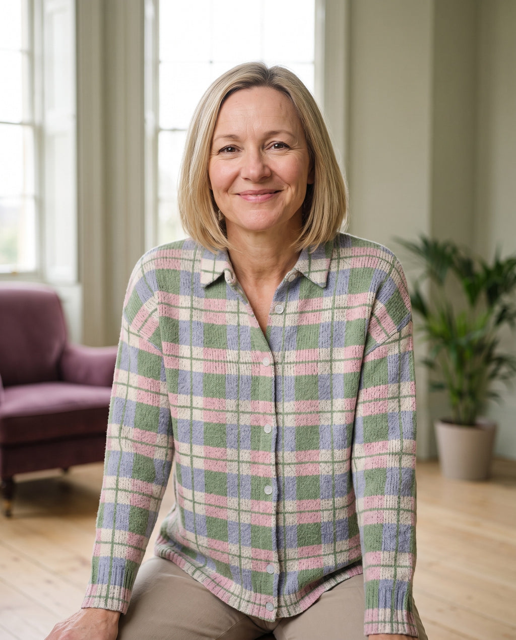 Woman wearing the checked knitted blouse in fresh pastel shades, close-up of the neckline and fabric
