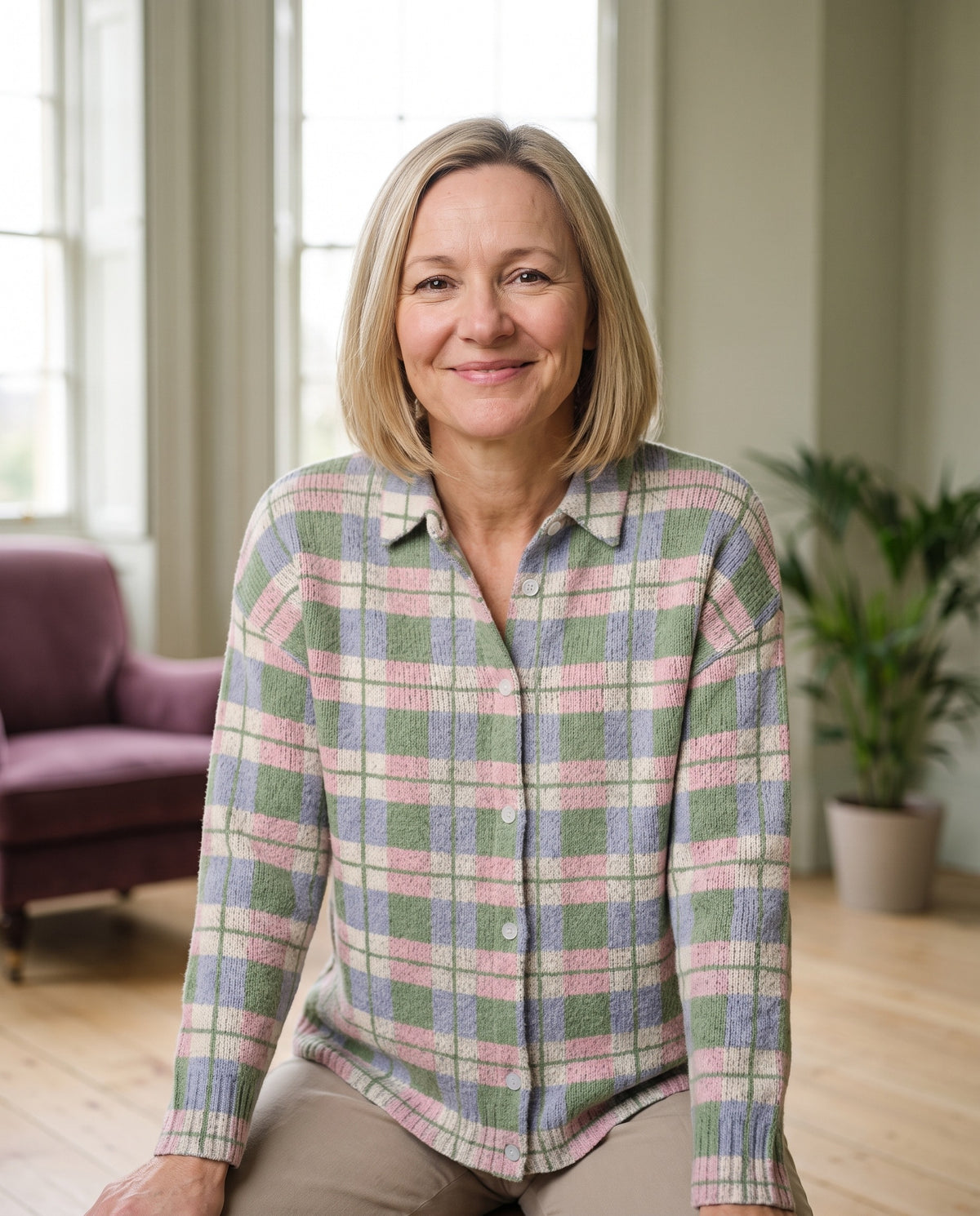 Woman wearing the checked knitted blouse in fresh pastel shades, close-up of the neckline and fabric Image
