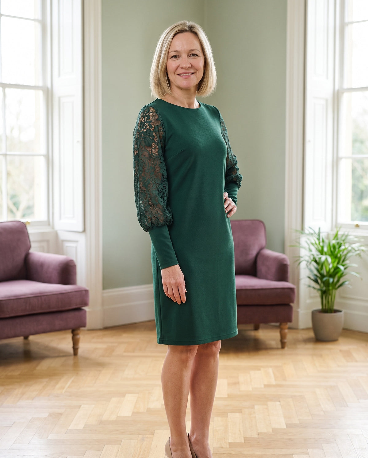 Woman wearing the lace balloon-sleeve shift dress in a bright Georgian interior Image