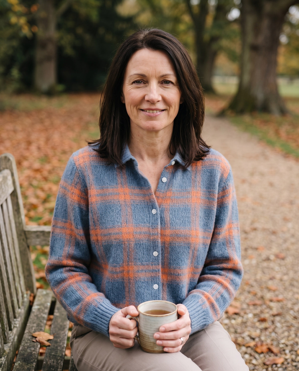 Woman wearing the knitted blouse with check pattern, close-up of the neckline and fabric Image