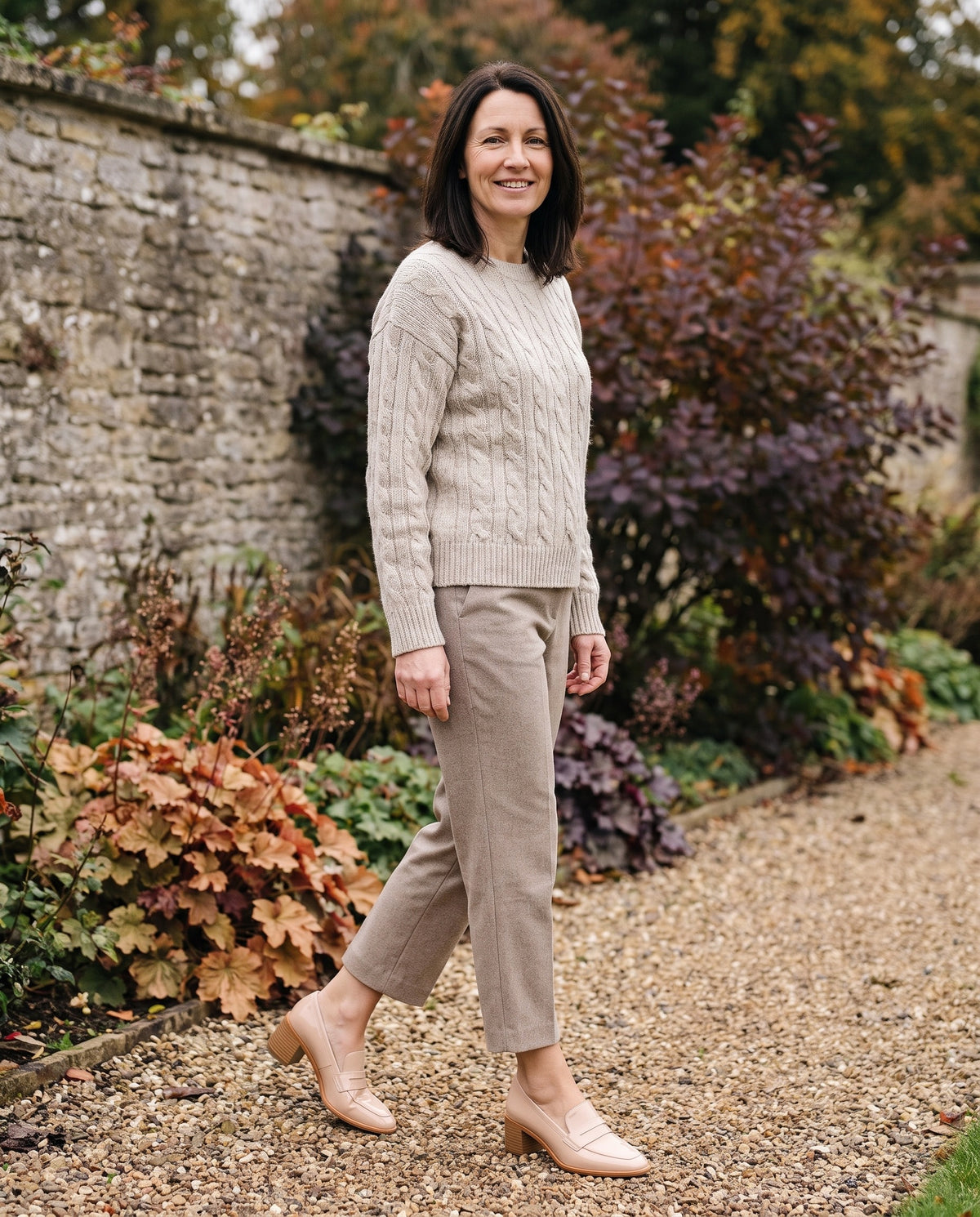 Woman wearing the orthopaedic loafers in an autumn English garden Image