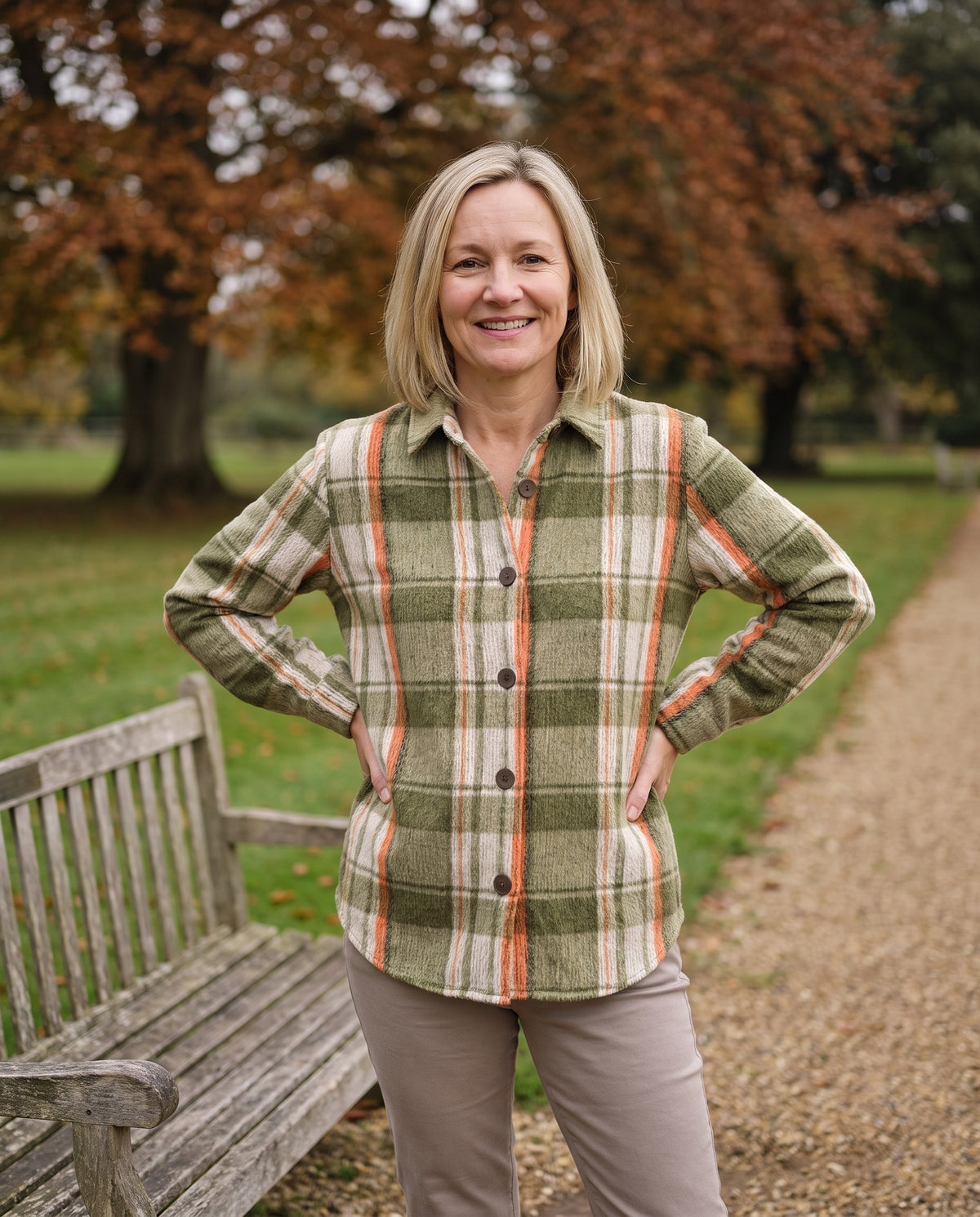 Woman wearing the checkered blouse in an English park in autumn