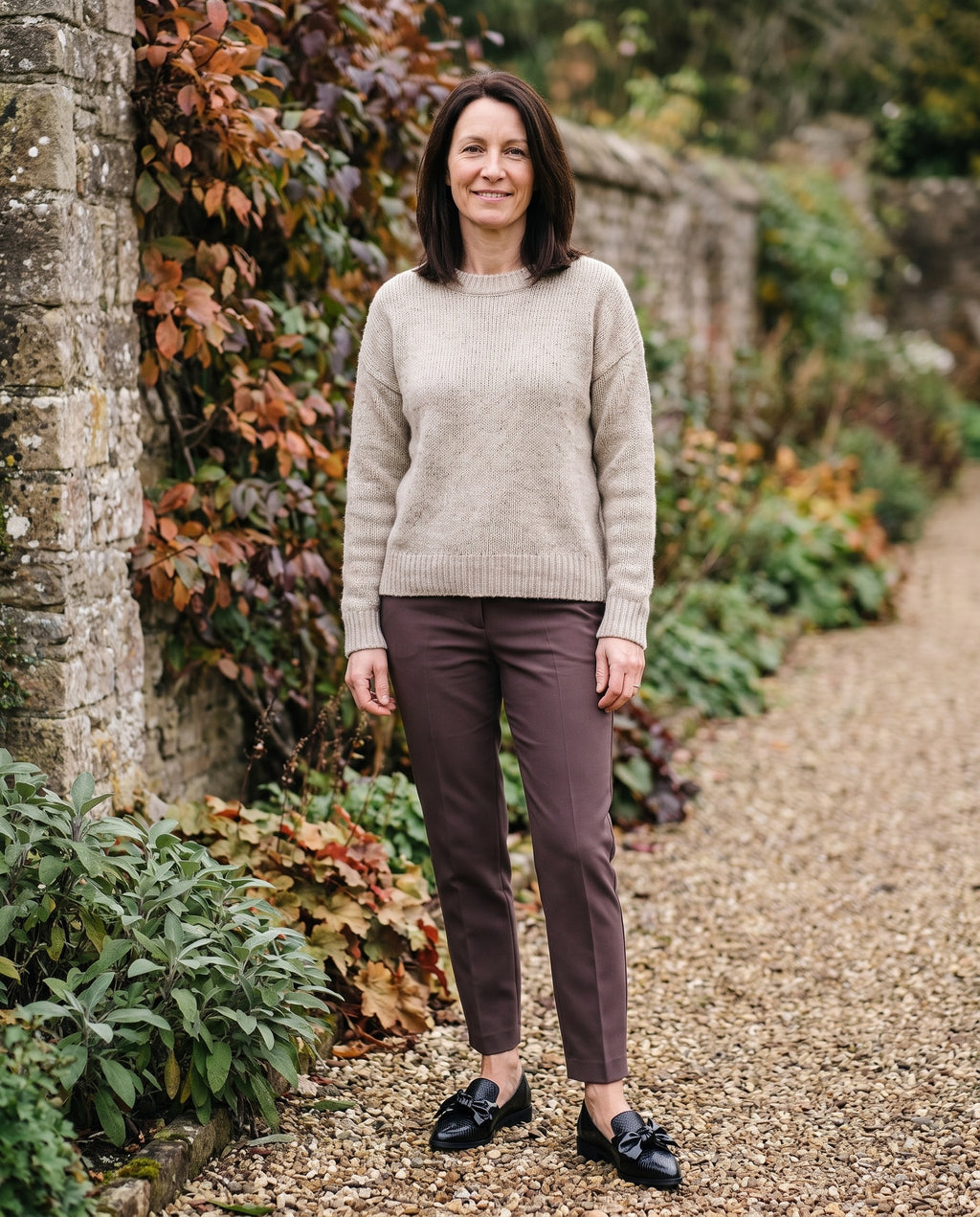 Woman wearing the elegant loafers in an autumn English garden