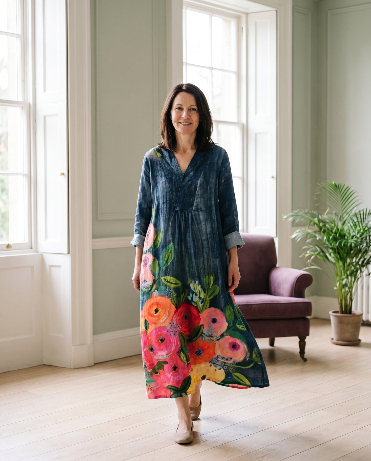 Woman wearing the elegant maxi dress in a bright Georgian interior