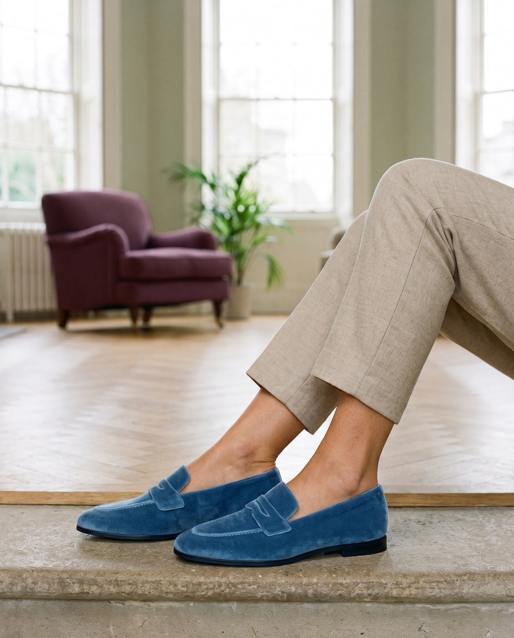Close-up of feet wearing the sophisticated loafers, seated on a stone step