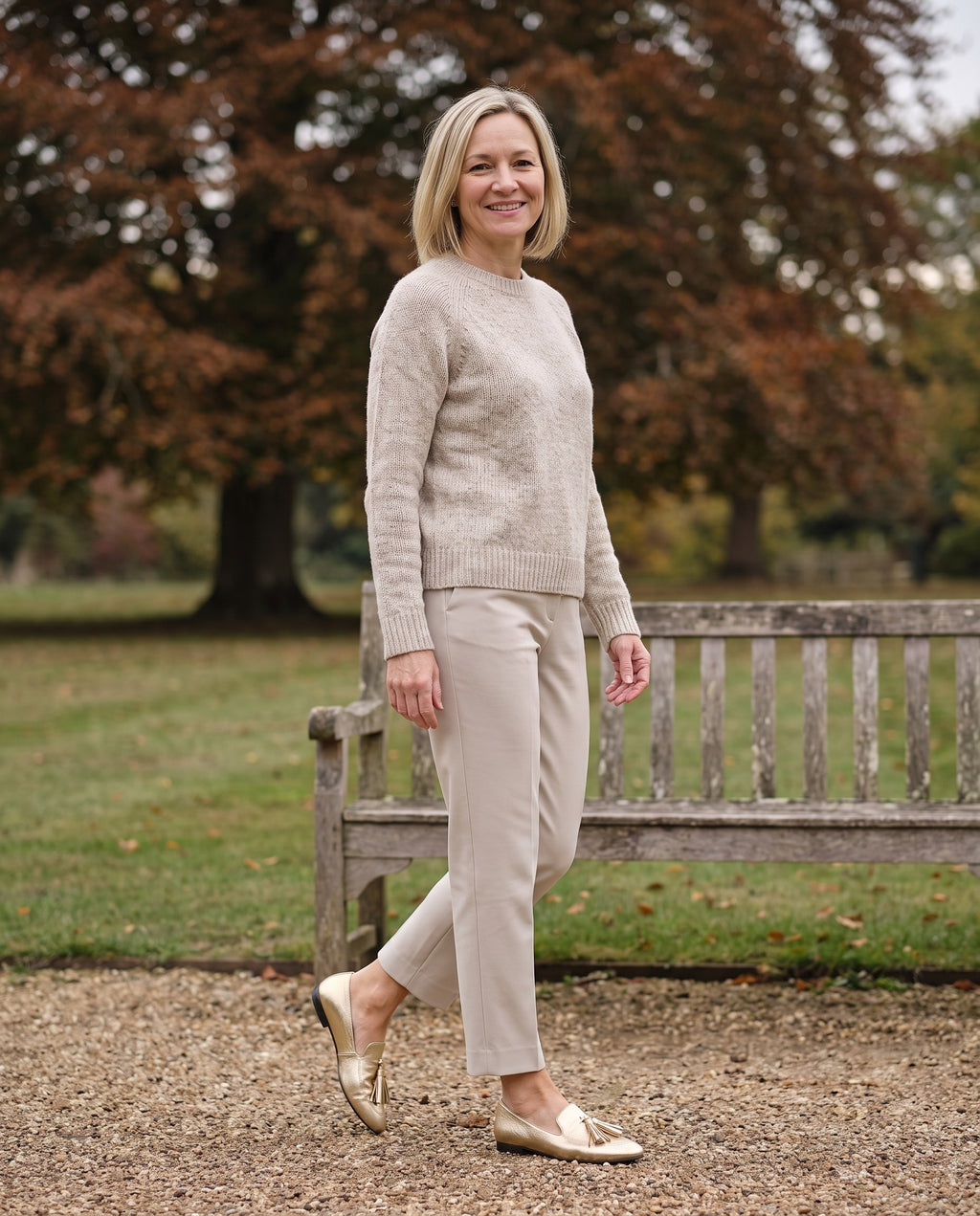 Woman wearing the gold loafers in an English park in autumn