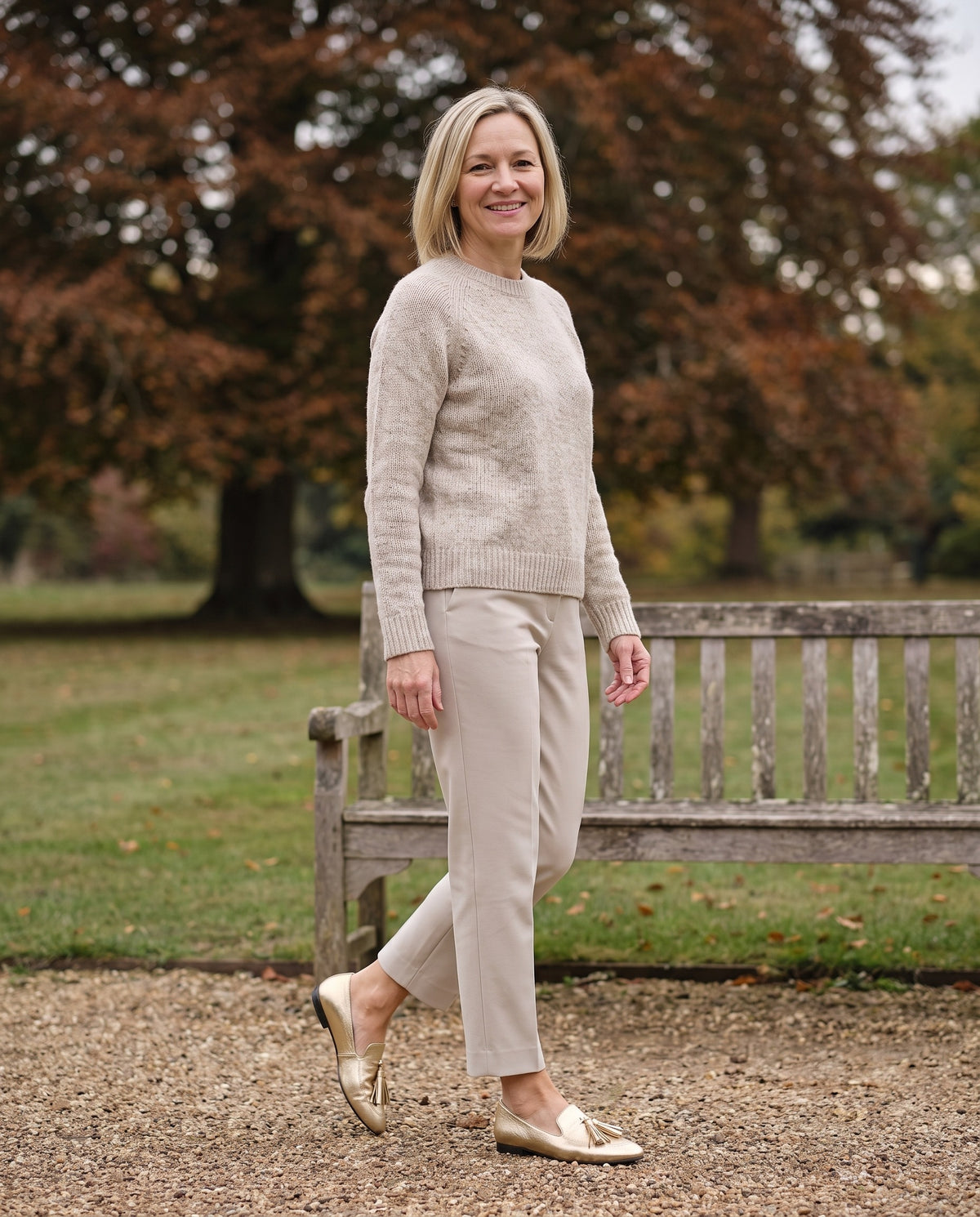 Woman wearing the gold loafers in an English park in autumn