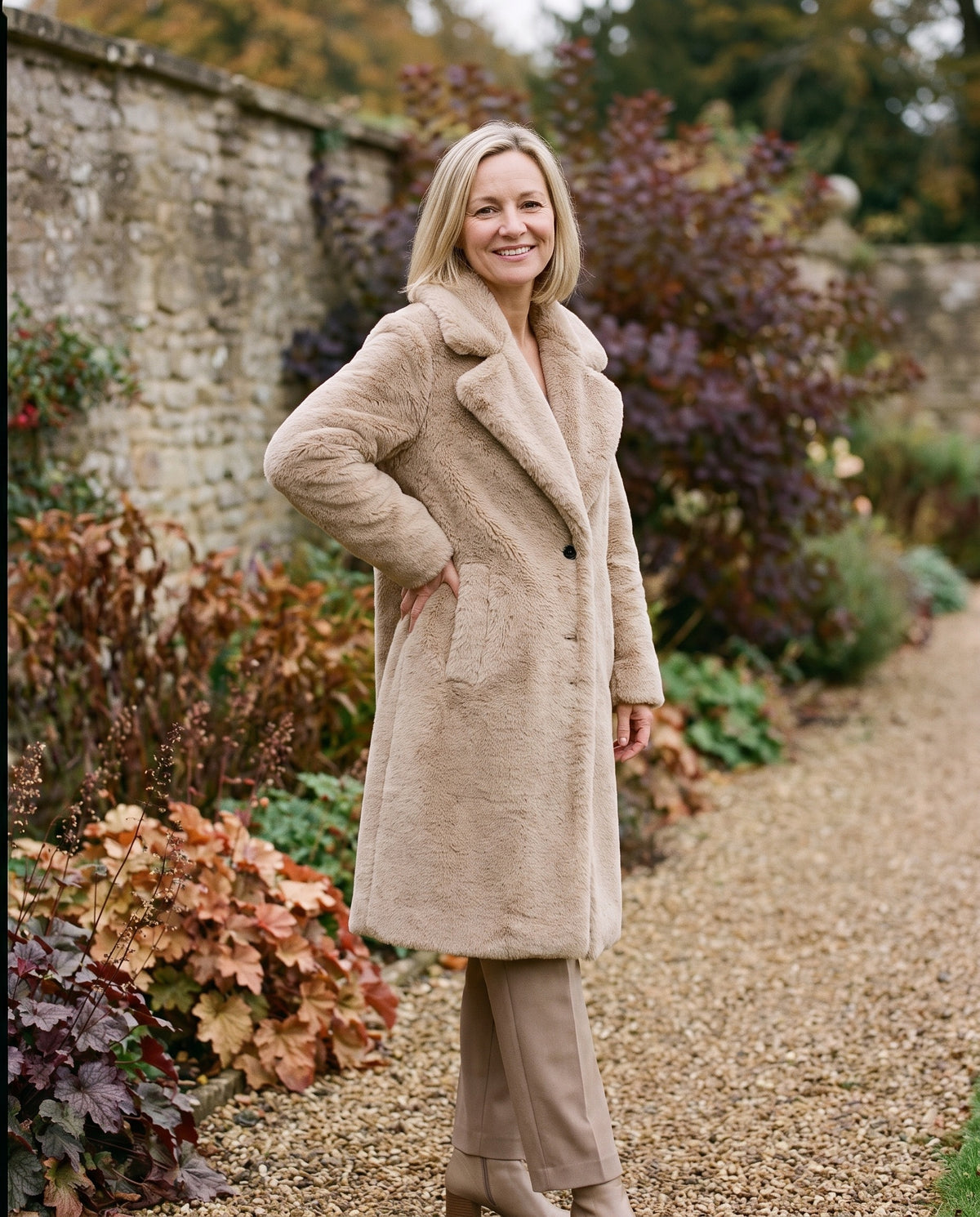 Woman wearing the teddy coat with wide notch lapels in an autumn English garden